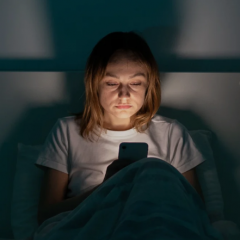 Person on the phone in bed