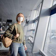 A woman with a mask on at an airport