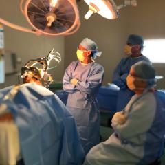 Surgeons in an operating theatre with a patient